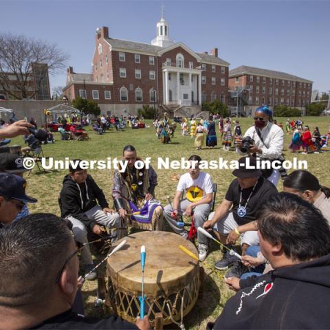 Omaha White Tail drummers play and sing during the UNITE powwow. 2022 UNITE powwow to honor graduates (K through college). Held April 23 on the greenspace along 17th Street, immediately west of the Willa Cather Dining Center. This was UNITE’s first powwow in three years. The MC was Craig Cleveland Jr. Arena director was Mike Wolfe Sr. Host Northern Drum was Standing Horse. Host Southern Drum was Omaha White Tail. Head Woman Dancer was Kaira Wolfe. Head Man Dancer was Scott Aldrich. Special contest was a Potato Dance. April 23, 2023. Photo by Troy Fedderson / University Communication.
